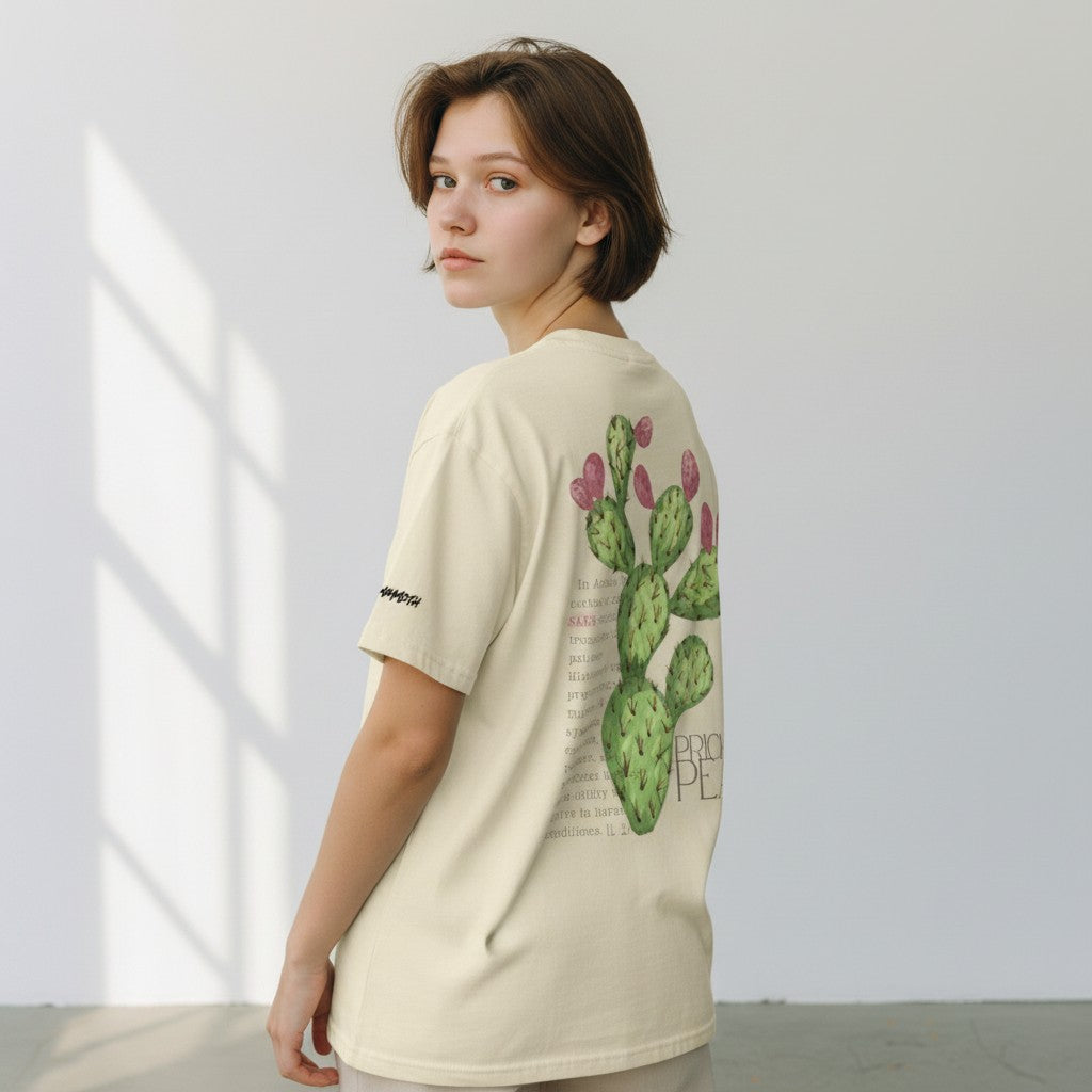 The Savage Mammoth Sabr loose boxy tee in apricot cotton with a large cactus graphic print on the back